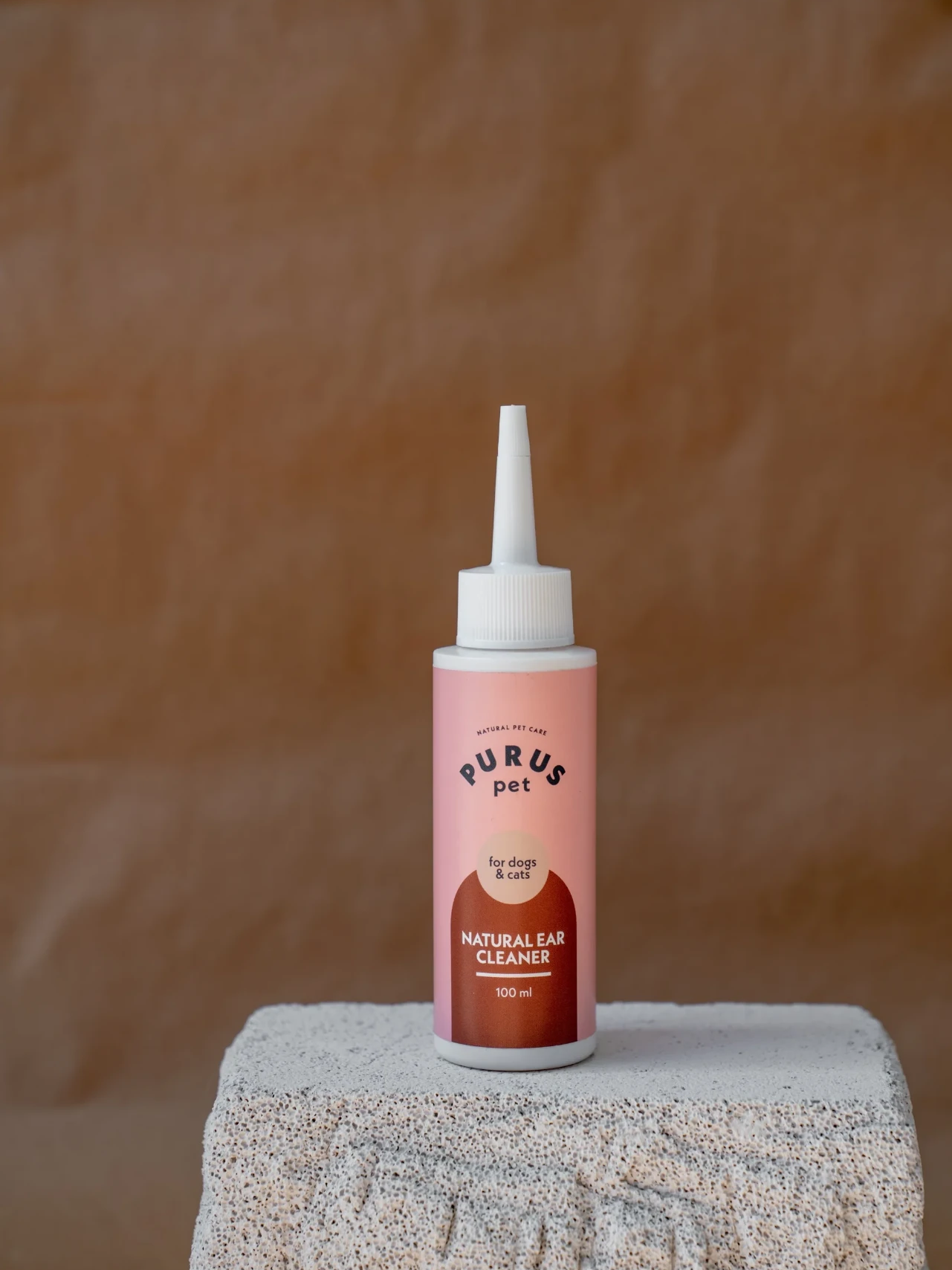 PURUS ear cleaner on a stone pedestal before transformation